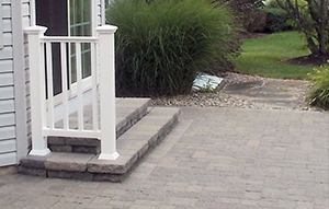 outdoor patio with steps and an attached safety railing